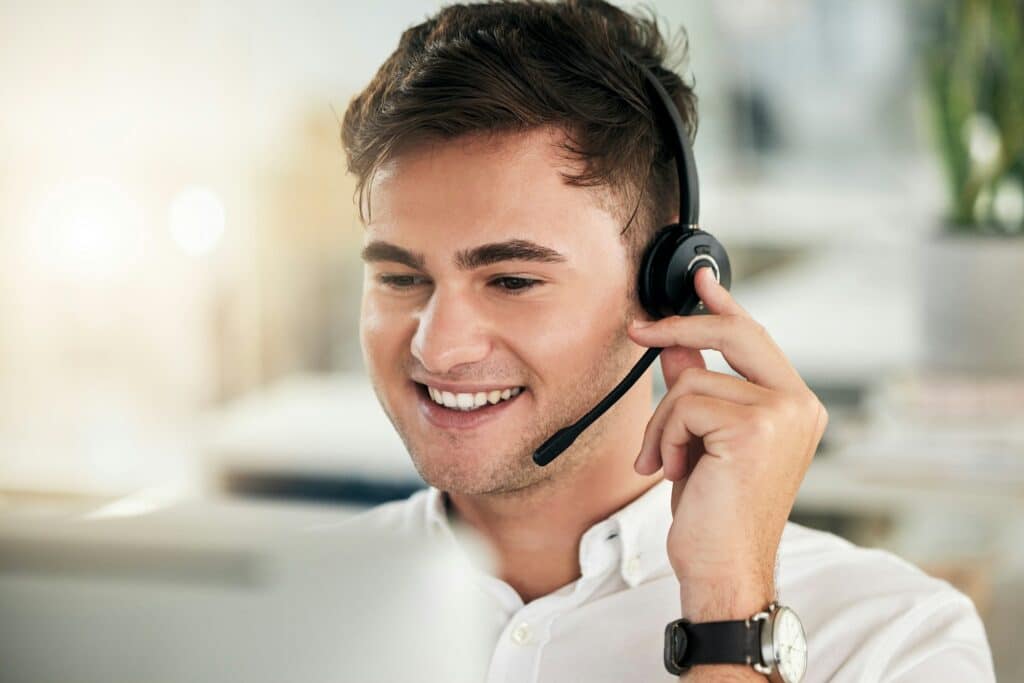 Headset, young man and call center for customer service, communication and sales growth. Telemarket