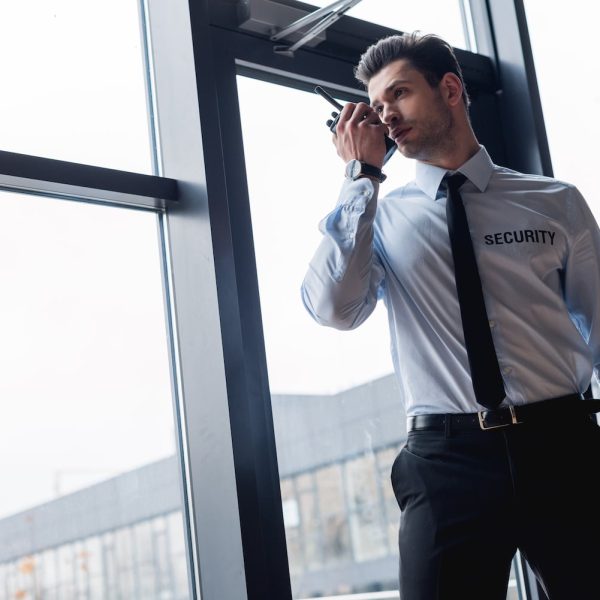 handsome guard in suit talking on walkie-talkie